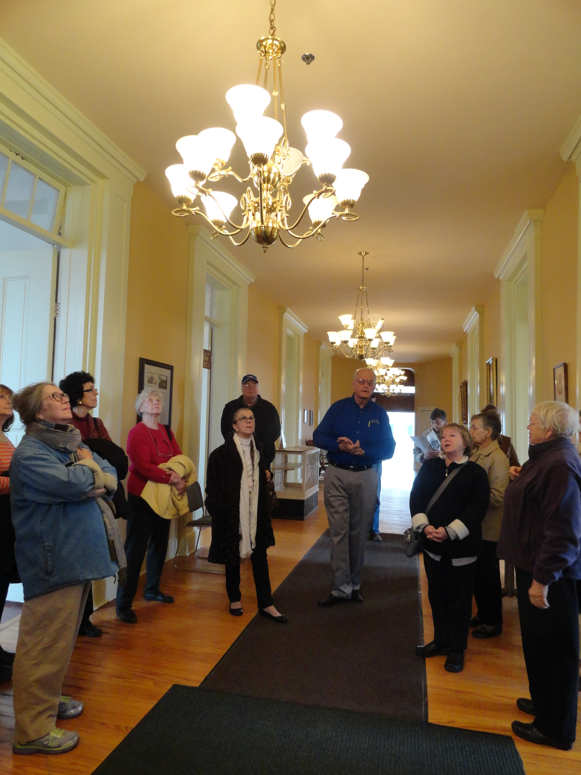 a dozen visitors viewing the chandeliers